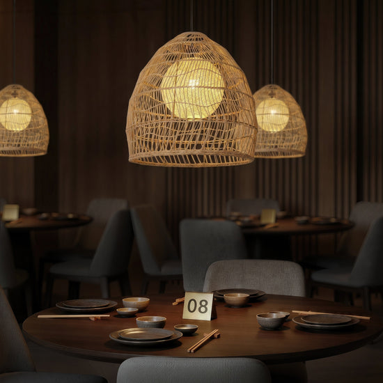 Rattan pendant light with inner sphere above a warm dining table